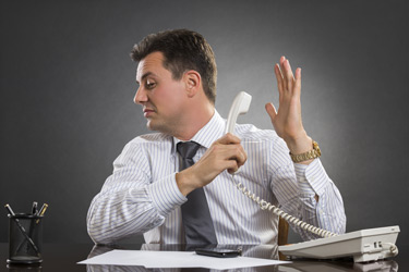 Bookkeeper ignoring customer on phone