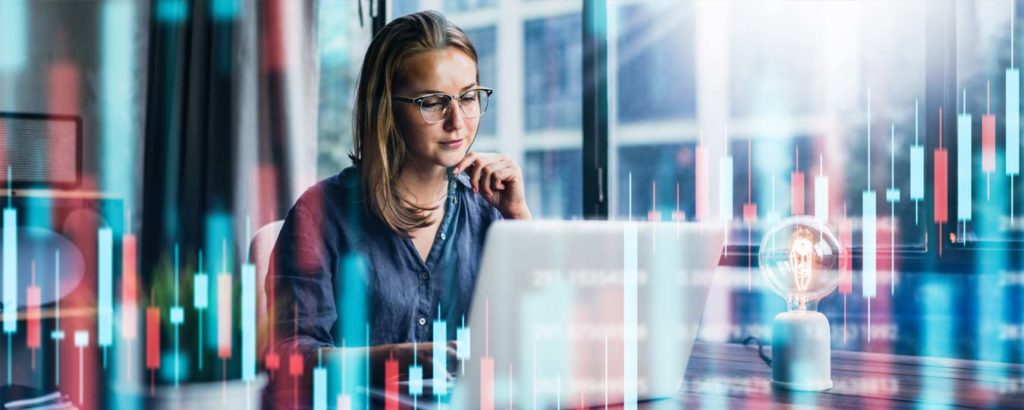 Women sitting at table looking at laptop