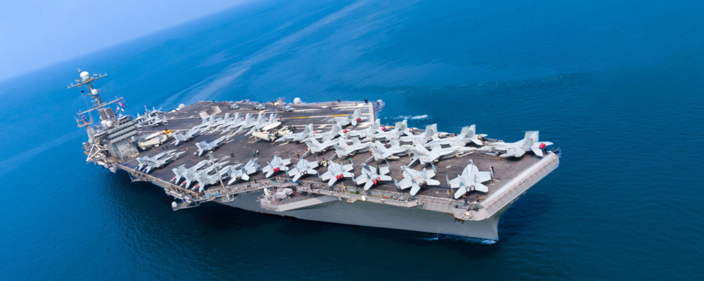 Navy War ship in water with navy jets on deck