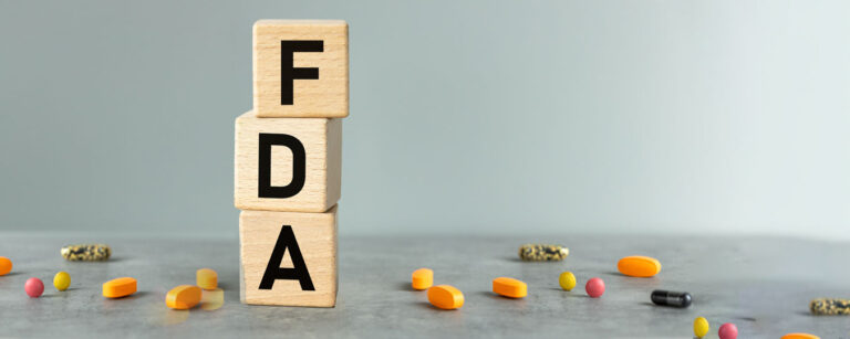 FDA on wood blocks surrounded by pills