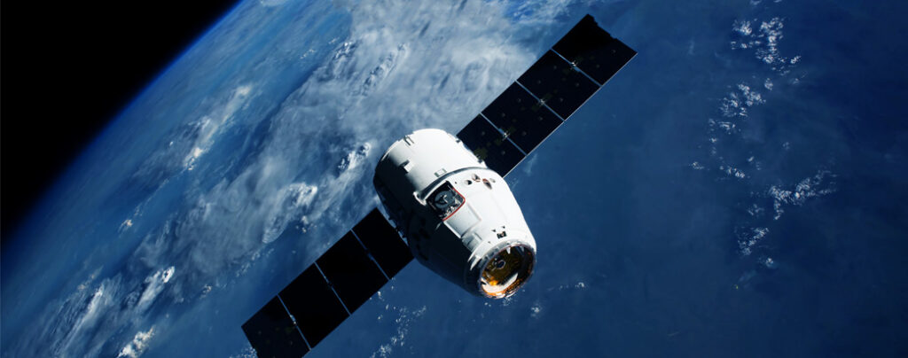 Satellite orbiting above Earth with solar panels extended.